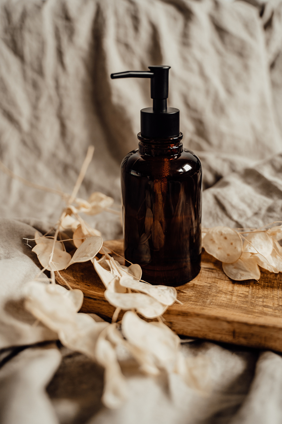 Amber Pump Bottle on a Wooden Tray 